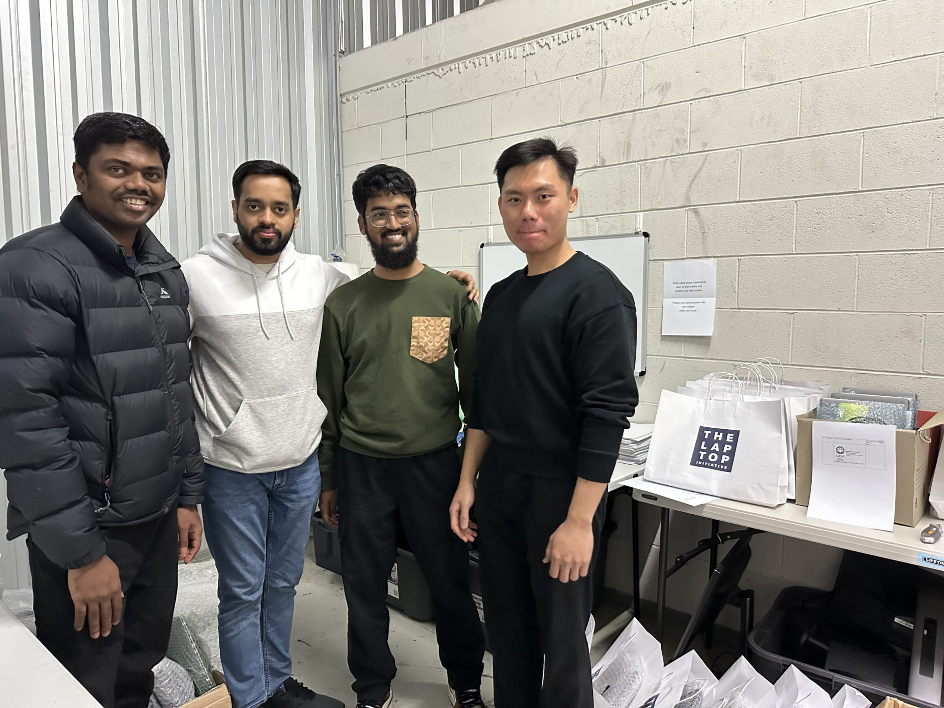 Volunteers packing donated laptops for delivery